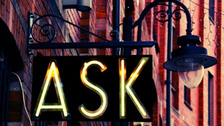 An image of an "ASK" sign outside of a building to symbolize 35 questions to ask your next broker.