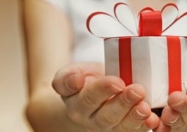 Two hands holding out a gift