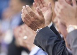 Focus shot of hands applauding in a crowd of people