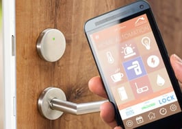 A phone with smart home technology unlocking the door.