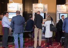 An industry trade show exhibit floor with attendees browsing the vendors.