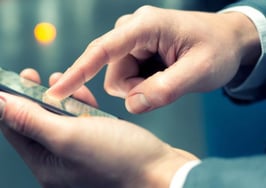 A pair of hands holding and using a smartphone