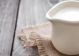 A jug of cream on a burlap napkin.