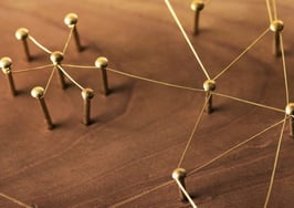 A network of threads connecting pins on a board