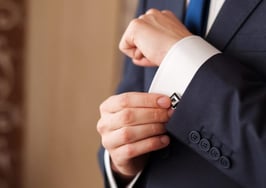 A man buttoning up his cufflinks