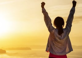A woman reaching the end of the finish line