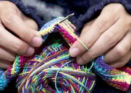 Hands knitting a scarf