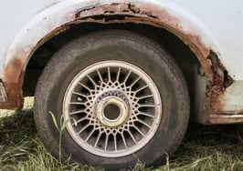 A rusted wheel well in a car