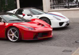 Two Italian sports cars, one red and one white, parked