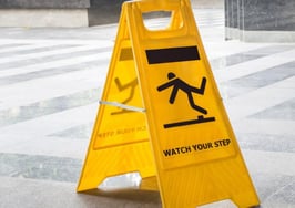 A "watch your step" sign with a figure slipping