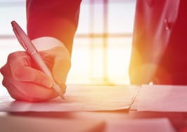 A businessman signing documents