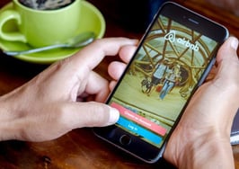 A man navigating Airbnb on his phone