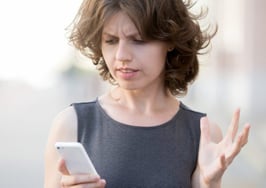 An irritated woman taking a phone call.