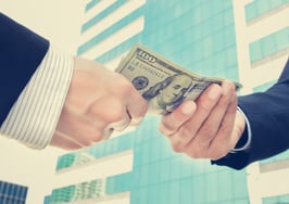 Businessmen exchanging money on the street