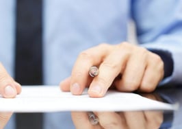 A man examining a contract closely