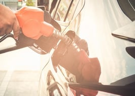 A man fueling up a car