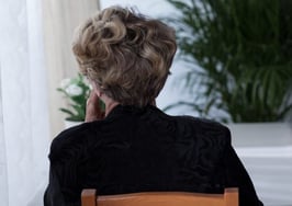 A retired woman sitting at a table