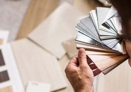A man examining flooring samples