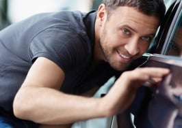 A man eyeing a car for sale