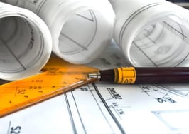 A set of blueprints on a desk