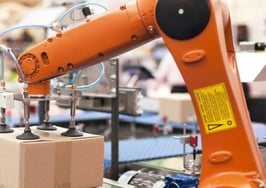 A robotic arm sealing up a package