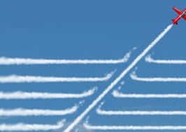 One fighter jet flying at an angle to others in the team