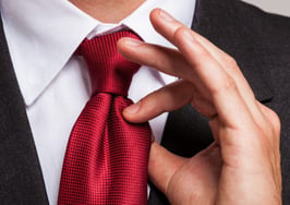 A man adjusting his necktie