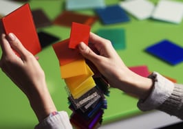 A young woman matching samples at a table