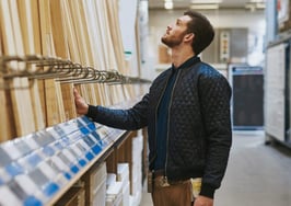 A carpenter looking at wood