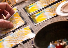 A Tarot card reader examining a spread