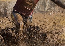 A racer running through mud