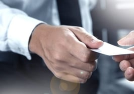 Two men exchanging business cards