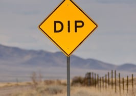 A sign on the road announcing a dip ahead