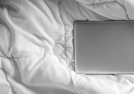 a laptop in bed