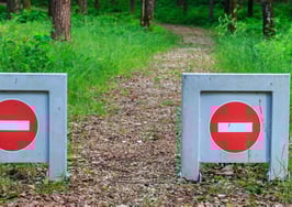 Two "no pass" signs set across a road