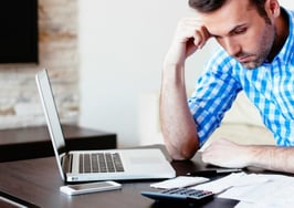 A young man working on his expenses