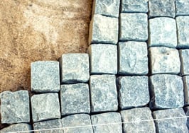 A man laying a path of stone
