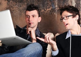 Two men on laptop computers