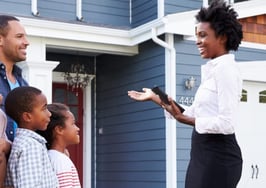 A real estate agent showing a home to a family