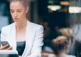 A young woman in a cafe checking her home