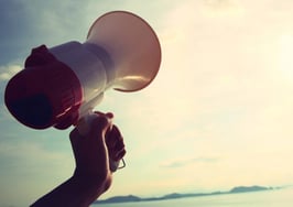 A megaphone held up to the sky