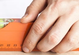 A man holding a level