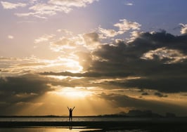 A man standing underneath a shining sun