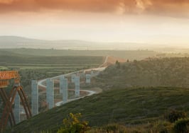 A bridge being built across a landscape