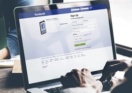 A man on Facebook in a cafe