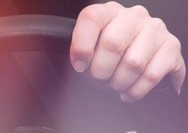 A woman's hands on a steering wheel