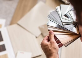A man looking at samples of paint and flooring