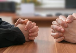 Two people at a negotiating table