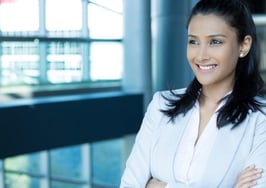 A young woman wearing a satisfied smile
