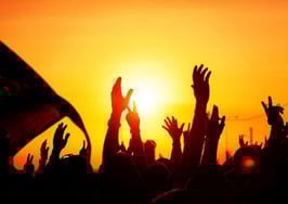 A silhouette of protesters against a sunset